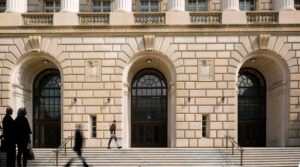 People walk by the Internal Revenue Service building